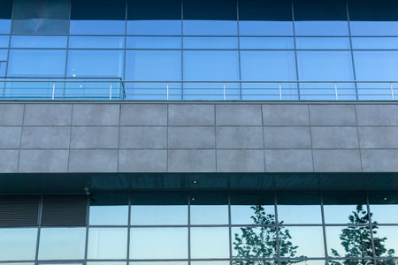 modern architecture, glass facade element with evening cityscape reflectionの写真素材