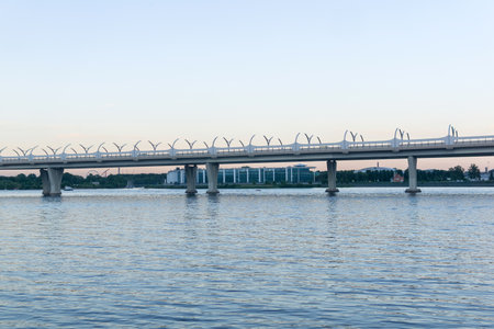 Evening cityscape with automobile bridge over riverの写真素材