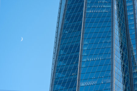 modern architecture, glass facade element of skyscraper against evening skyの写真素材