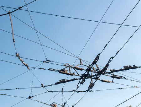 industrial urban background, intertwining cables over the street at the intersection of trolleybus contact wiresの写真素材