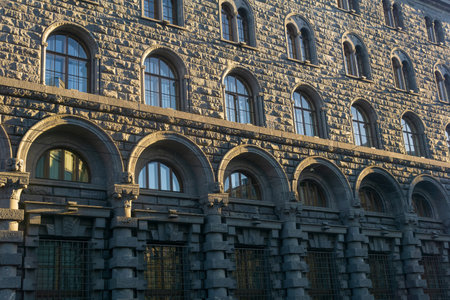 architectural background, dark facade of an old city building, barely illuminated by the morning sun raysの写真素材