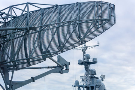 military background, naval radar antenna close up and warship in the backgroundの写真素材