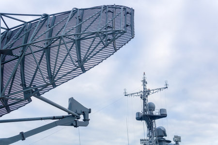 military background, naval radar antenna close up and warship in the backgroundの写真素材