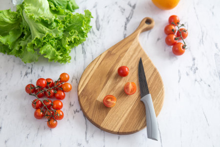 cherry tomatoes on a cutting board before slicingの写真素材