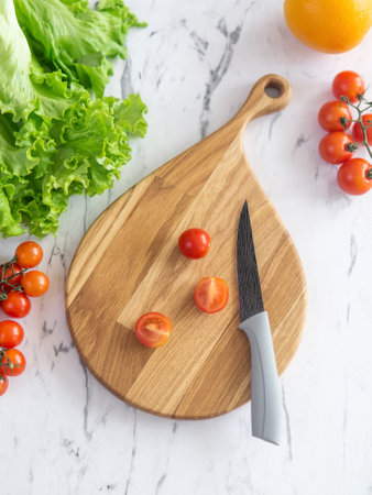 cherry tomatoes on a cutting board before slicingの写真素材