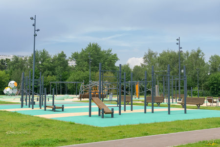 sports ground and playground for children in the summer park.