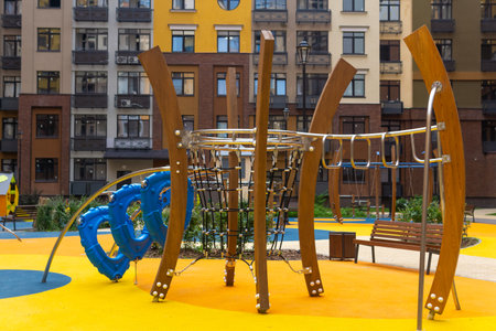Children's playground in the yard of a residential building in the cityの写真素材