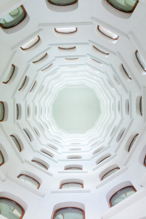 architectural background, spiral staircase with windows opening into a skylight under the domeの写真素材