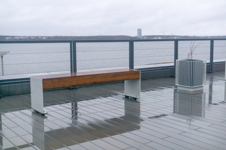 View of the benches on the embankment on a rainy day