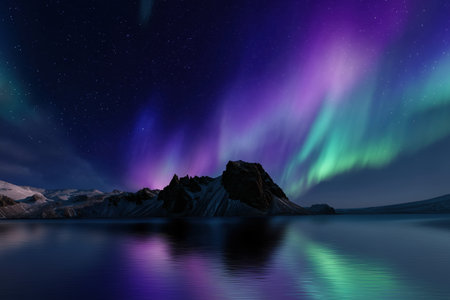 Aurora borealis, northern lights over a mountain lake in Icelandの素材
