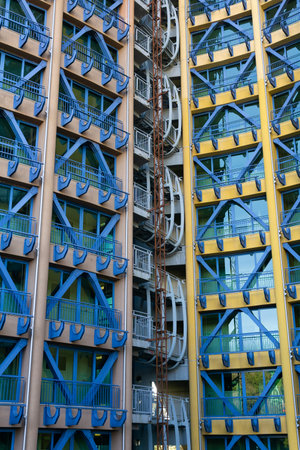 Facade of a multi-storey building with blue metal structures
