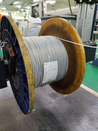 Plastic coil of white electrical cable production at factoryの写真素材