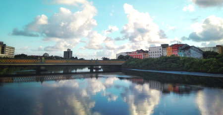 A panoramic shot of a river with a bridge in the backgroundの写真素材