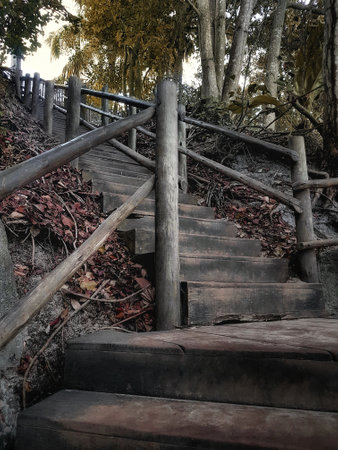 Wooden stairs leading down to the sea in autumn. Selective focus.