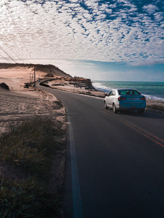 Car driving on the road in Algarve, Portugal at sunsetの写真素材