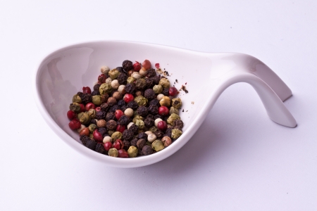 colored grains of pepper, close-up on a white background の写真素材