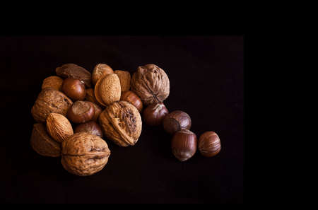 Variety of nuts isolated on a black backgroundの写真素材