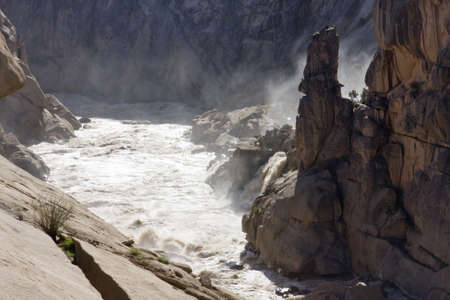 A misty river flowing through a canyonの写真素材