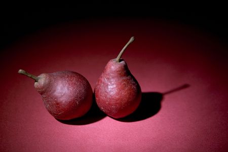 two pears on violet backgroundの写真素材
