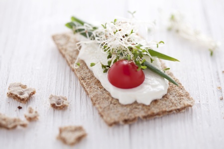 crisp bread sandwich with cream cheese, broccoli sprouts, tomato and chiveの写真素材
