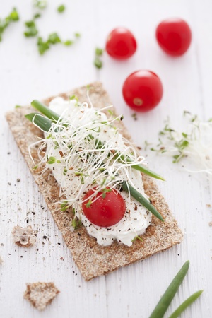 crisp bread sandwich with cream cheese, broccoli sprouts, tomato and chiveの写真素材