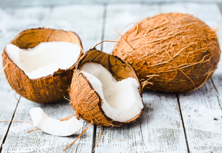 Fresh coconuts in the shell on a blue  wooden background, tropical fruit
