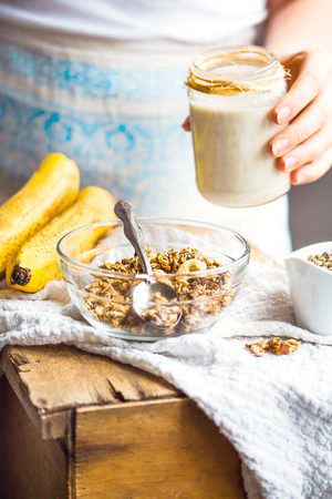 jar of hemp seed milk, hold in your hand, a healthy breakfast, light backgroundの写真素材