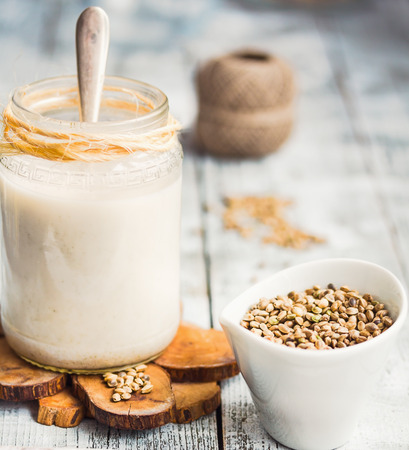 homemade vegan milk from hemp seeds in a glass jar, close-upの写真素材
