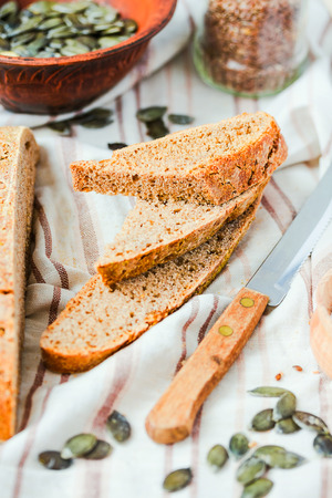 homemade rye bread unleavened with flax seed and pumpkin, slices, healthy organic food, selective focus,closeupの写真素材