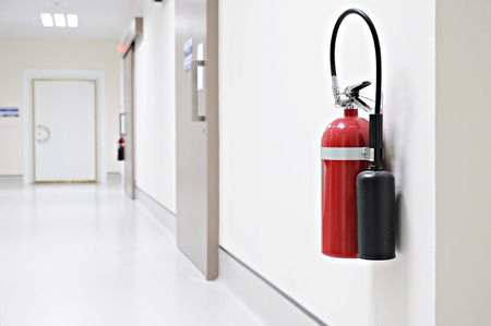 Install a fire extinguisher on the wall in buiding