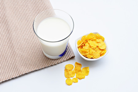Corn flakes in Cup and Fresh Milk in Glass  Place on white background