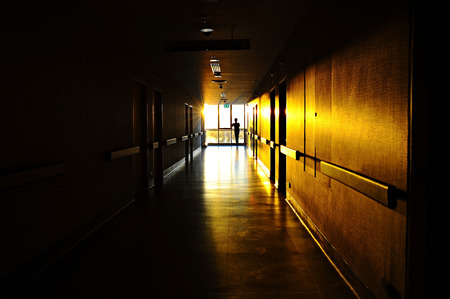 Seeing the light, shafts of sunset stream through windowの写真素材