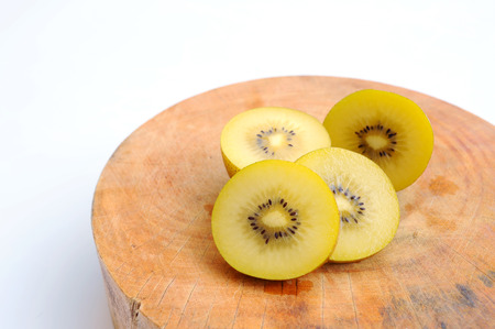 Fresh kiwi with slices place on wooden, white background の写真素材