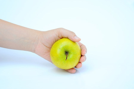 dried green apple lay in hand on white backgroundの写真素材