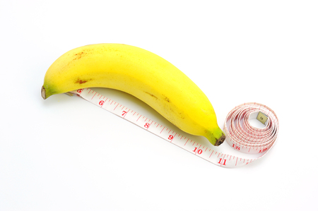 Golden Banana or "Kluai Hom" and Measuring Tape Representing on white backgroundの写真素材