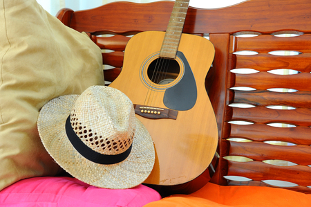accoustic guitar resting against a sofaの写真素材