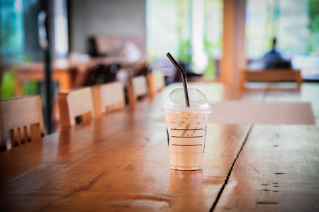 iced coffee on wood table (Style Still Life)の写真素材