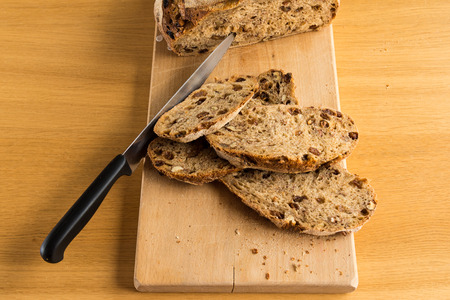 Handmade bread is cutting by a sharp