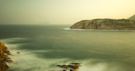 Sunset, Waves and Mountain in a Village of Hong Kong Islandの写真素材