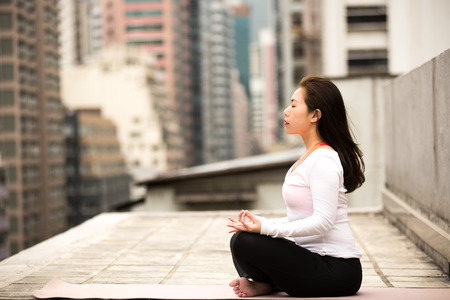 Meditating on a Rooftop in Hong Kong Islandの写真素材