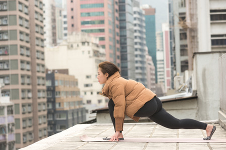 Stretching on a Rooftop with a Jacket in Hong Kong Island