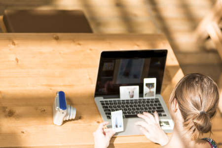 Overhead: Girl looking at her self-portrait Photos in a Cafeteriaの写真素材