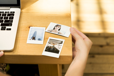 Woman observing her Photos in a Caffeeの写真素材