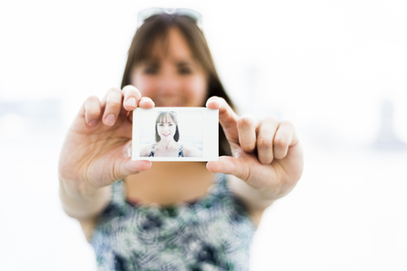 Woman showing her Self-portrait in a sunny Dayの写真素材