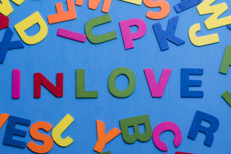 Inlove written in wood Letters on a blue Backgroundの写真素材