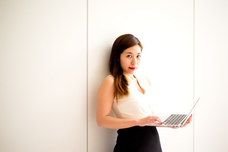 Woman looking at Camera while working in an Office