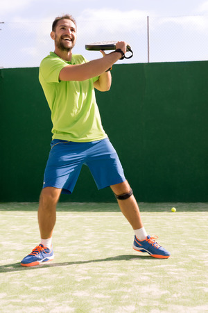 Laughing while playing Tennis in a sunny Dayの写真素材