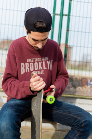 Cute Guy reparing his Skateの写真素材