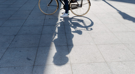 Shadow and Light of a Man with his Bike