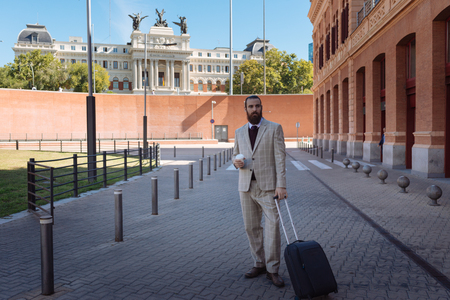 Businessman holding a warm Coffee on the Streetの写真素材